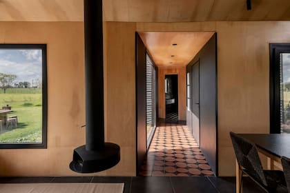 El piso calcáreo del pasillo (Noi Estudio) se diseñó con los mismos colores que el resto de la casa.