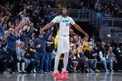 El pívot de los Pacers de Indiana, Myles Turner celebra luego de encestar un triple ante el Heat de Miami, durante la segunda mitad del juego de baloncesto de la NBA, en Indianápolis, el domingo 17 de noviembre de 2024. (AP Foto/Michael Conroy)