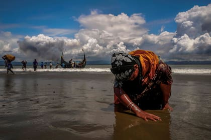 Una mujer refugiada rohingya, agotada por el cansancio, toca la orilla después de cruzar la frontera entre Bangladesh y Myanmar, Bangladesh (11 de septiembre de 2017)