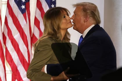 El presidente Donald Trump besa a la primera dama Melania Trump después de su discurso a la Convención Nacional Republicana en la Casa Blanca, anoche
