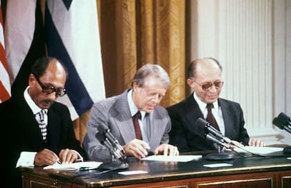 El presidente egipcio Anwar Sadat, el presidente estadounidense Jimmy Carter y el primer ministro israelí Menachem Begin, firmando los Acuerdos de Camp David en 1978.