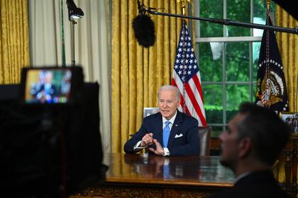 El presidente Joe Biden habla ante la nación sobre el acuerdo presupuestal que eleva el tope del endeudamiento federal y evita una mora de pagos del gobierno de Estados Unidos, el viernes 2 de junio de 2023, desde la Oficina Oval de la Casa Blanca, en Washington. (Jim Watson/Foto compartida vía AP)