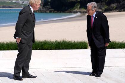 El primer ministro británico Boris Johnson saluda al secretario general de la ONU Antonio Guterres en su arribo a la reunión del G7 en Carbis Bay, Cornualles, Inglaterra. La ONU reeligió a Guterres como secretario general por un nuevo quinquenio el viernes 18 de junio de 2021. (AP Foto/Kirsty Wigglesworth, Pool)