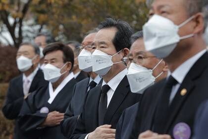 El primer ministro de Corea del Sur, Chung Sye-kyun, tercero desde la derecha, con un tapabocas durante una ceremonia para conmemorar el 81 aniversario del Día Conmemorativo de los Ancestros Mártires, hoy, en Seúl, Corea del Sur