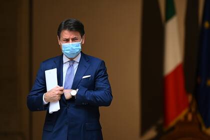 El primer ministro de Italia, Giuseppe Conte, con una mascarilla protectora, llega a una conferencia de prensa sobre las medidas recientemente adoptadas para luchar contra la propagación del Covid-19, en el patio del Palacio Chigi, en Roma, el 25 de octubre de 2020