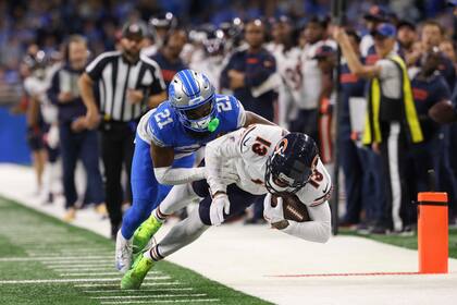 El receptor de los Bears de Chicago Keenan Allen recibe el balón cerca de la zona de anotación mientras lo defiende el cornerback de los Lions de Detroit Amik Robertson en el encuentro del jueves 28 de noviembre del 2024. (John J. Kim/Chicago Tribune via AP)