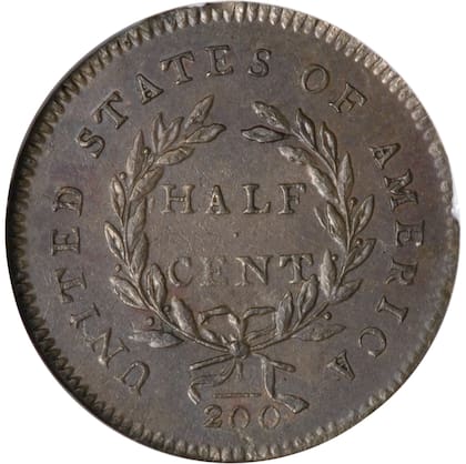 El reverso de esta moneda muestra cinco bayas en la rama izquierda de la corona y cuatro en la derecha