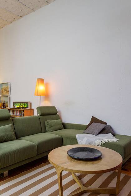 El rincón de la tele se disfruta gracias a un sofá en L (Facyca) y una mesa ratona de pergamino (Amparo Be)