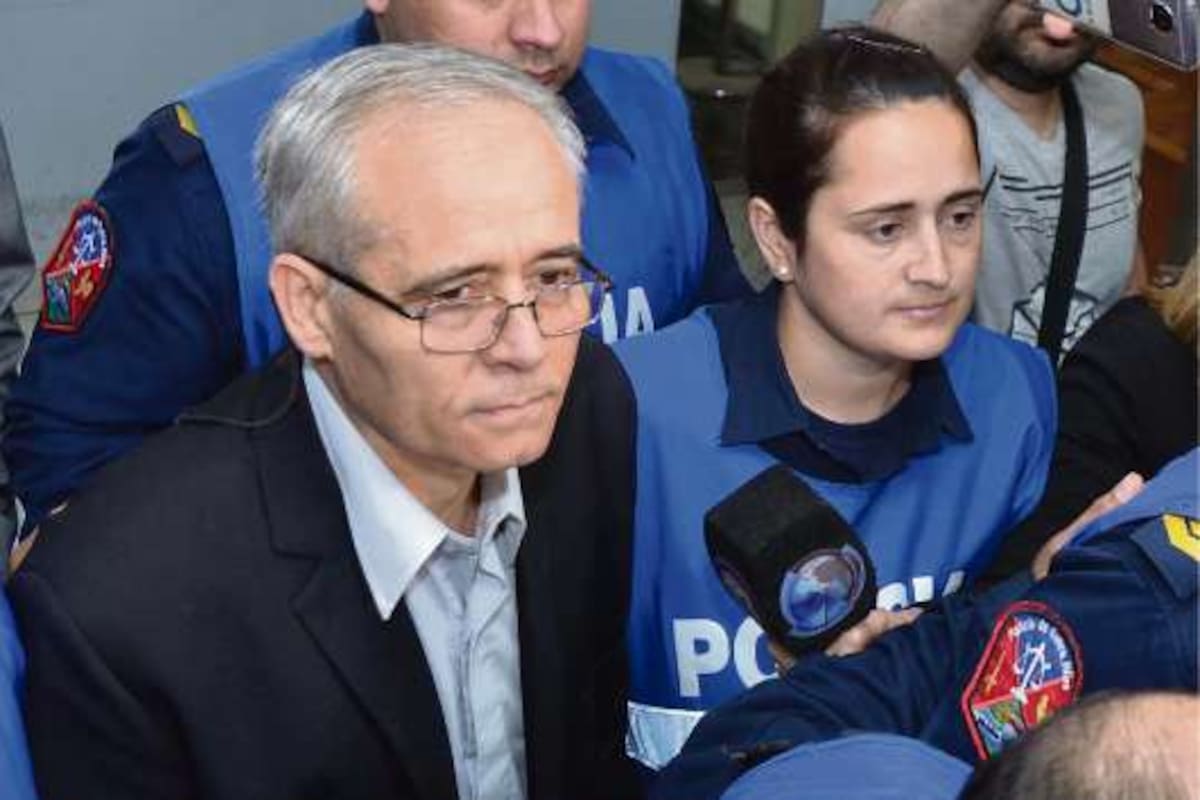 El sacerdote Justo José Ilarraz ingresa en la sala de audiciencia custodiado por la policía