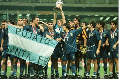 El sub 20 argentino campeón en Malasia 1997; el capitán Esteban Cambiasso levanta la copa y el hoy seleccionador nacional Lionel Scaloni sostiene una bandera.