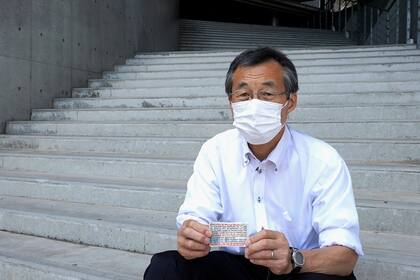 El voluntario olímpico Atsushi Muramats muestra un pequeño folleto en el que expresa gratitud por el apoyo extranjero, durante una entrevista con The Associated Press, el jueves 29 de julio de 2021, en Rifu, Japón. (AP Foto/Chisato Tanaka)
