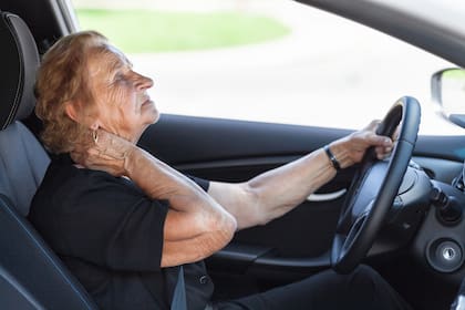 Elderly woman behind the steering wheel of a car