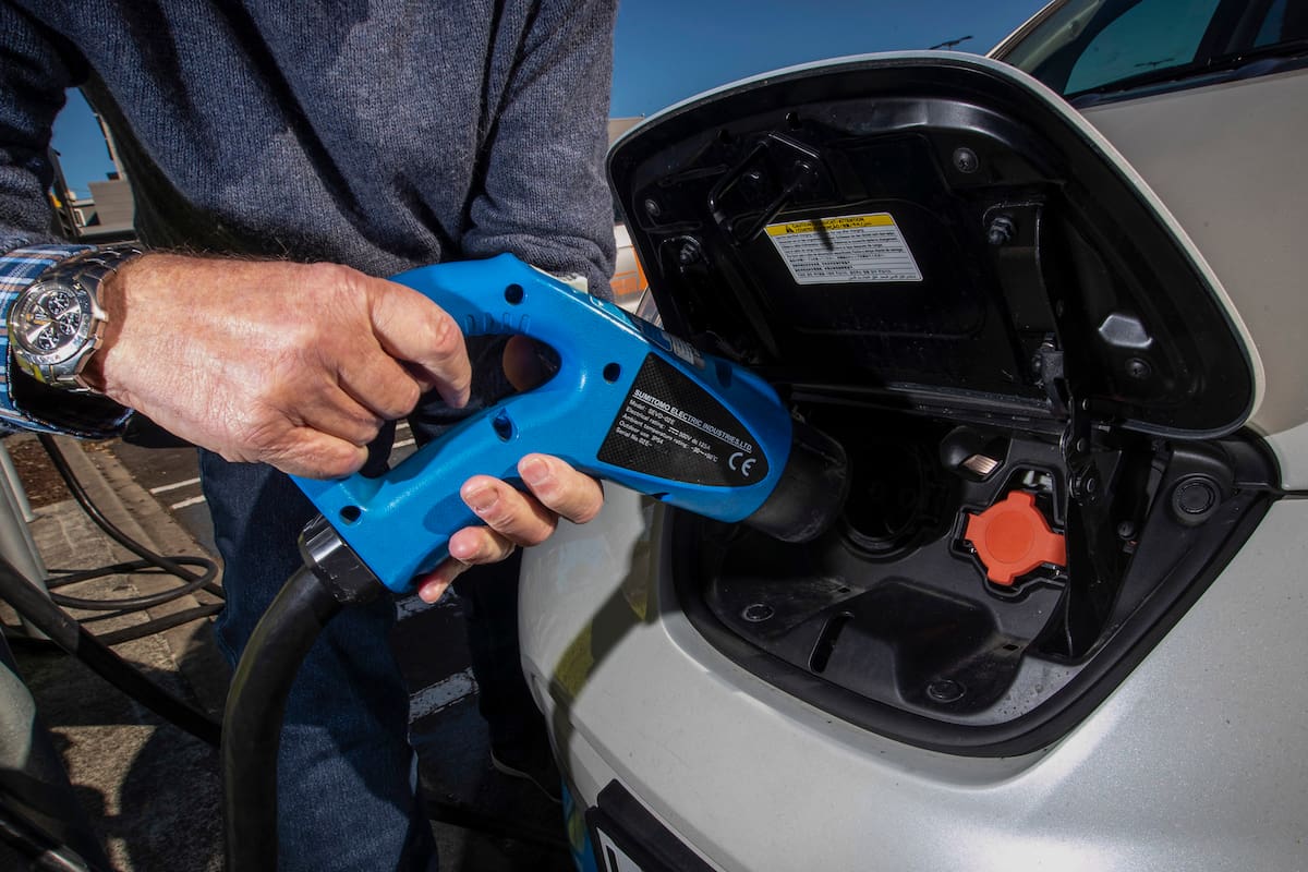 Electric vehicle charging station is shown at a carpark in Auckland, New Zealand, July 1, 2021. New Zealand will help pay for lower-income families to scrap their old gas guzzlers and replace them with cleaner hybrid or electric cars as part of a sweeping plan to reduce greenhouse gas emissions the government announced Monday, May 16, 2022. (Jason Oxenham/New Zealand Herald via AP)