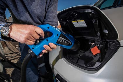 Electric vehicle charging station is shown at a carpark in Auckland, New Zealand, July 1, 2021. New Zealand will help pay for lower-income families to scrap their old gas guzzlers and replace them with cleaner hybrid or electric cars as part of a sweeping plan to reduce greenhouse gas emissions the government announced Monday, May 16, 2022. (Jason Oxenham/New Zealand Herald via AP)