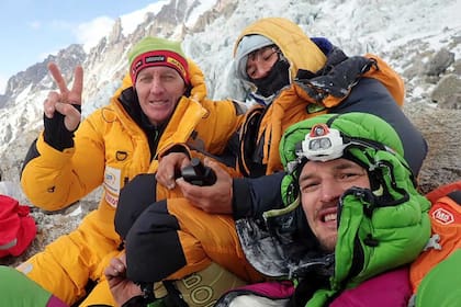Elisabeth Revol entre el escalador ruso Denis Urubko y el polaco Adam Bielecki, posando para una foto en la base de la Cara Diamir de Nanga Parbat