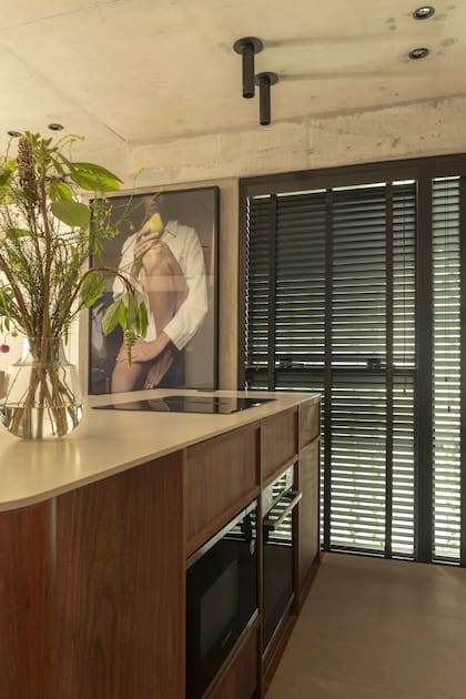 En el área de uso intensivo, piso de porcelanato ‘Adeona Antiq Duo’ (San Lorenzo Design). El horno y el microondas están empotrados en la isla. Apliques ‘Cavia’ (Boutique de Luz). Mesadas de Purastone Prima ‘Limestone’ (Mutra Marmolería).