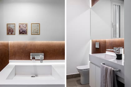 En el baño se retoma el concepto del acero, aunque acompañado de una paleta cálida.