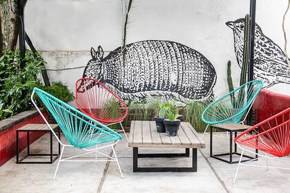 En el barrio porteño de Coghlan, una casa antigua inspira la decoración de una terraza con potencial, con un mural realizado por Teófilo Riadigos que se completa con muebles simples y coloridos