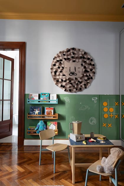 En el cuarto de un niño de 4 años, mesita laqueada y sillas ‘Mini Yey’ en hierro y madera (todo de El Yeti).