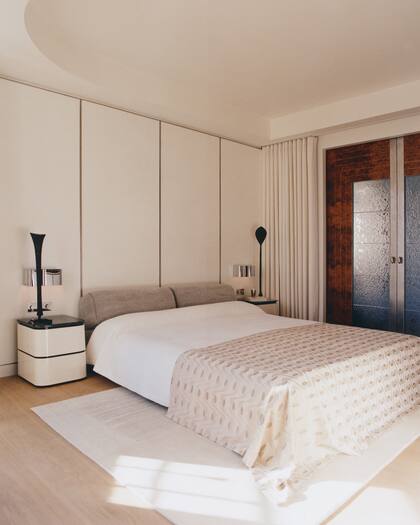 En el dormitorio predominan los colores claros y la madera veteada. El cubrecama de terciopelo es de Sabina Fay Braxton (Jules et Jim).