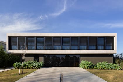 En el frente, el verde de las plantas constrasta con el gris del cemento _ Arq. Mariano Fiorentini / Fotografía: Ramiro Sosa.