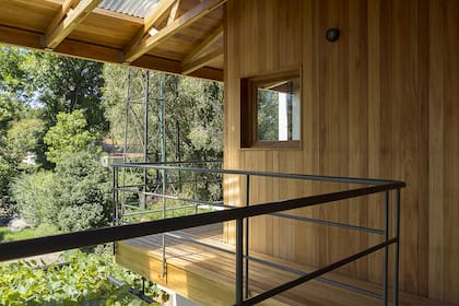 En el vértice del techo, una raja de luz. La baranda de la galería tiene el mismo diseño que la de la escalera interior y el espaldar del patio.