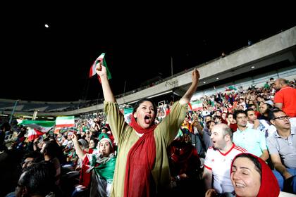 En esta foto de archivo tomada el 25 de junio de 2018, una mujer iraní aplaude mientras mira el partido de fútbol del Grupo B de la Copa Mundial entre Portugal e Irán en el estadio Azadi en Teherán