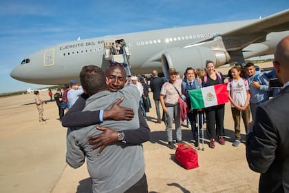 En esta foto facilitada por el Ministerio de Defensa español pasajeros de Sudán desembarcan de un avión de la Fuerza Aérea Española en la Base Aérea de Torrejón en Madrid, el lunes 24 de abril de 2023.