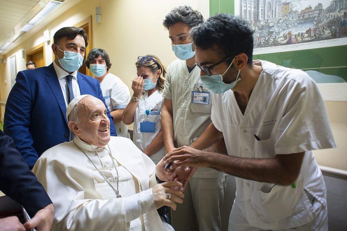 En esta imagen de archivo, el papa Francisco es recibido por el personal hospitalario a su entrada, en silla de ruedas, en el policlínico universitario Agostino Gemelli en Roma, el 11 de julio de 2021, antes de someterse a una operación intestinal. (Vatican Media vía AP, archivo)