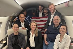 En esta imagen difundida por el gobierno de Estados Unidos, el periodista estadounidense Evan Gershkovich (izq.), el exmarine estadounidense Paul Whelan (2do. der.) y la periodista ruso-estadounidense Alsu Kurmasheva (der.) aparecen en un avión tras su liberación de Rusia el 1 de agosto de 2024. (AFP)