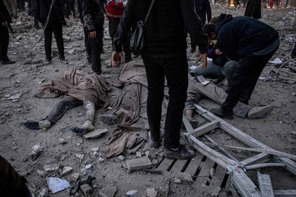En esta imagen obtenida de la agencia de noticias iraní ISNA el 3 de marzo de 2026, varios cuerpos yacen en el suelo tras un ataque contra un edificio en la plaza Enghelab, en Teherán