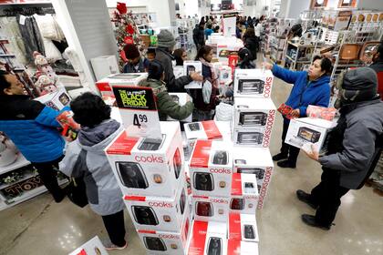 En JCPenney en Niles, Illinoism, los artículos en oferta son apilados hasta agotar su stock, los compradores se apuran para aprovechar la oferta