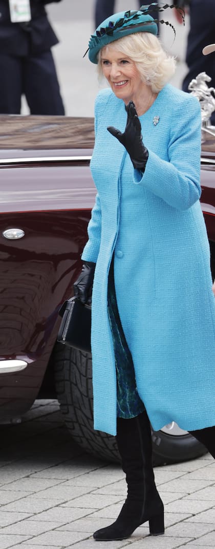 En la Puerta de Brandeburgo, Camilla lució un tapado de Bruce Oldfield, el diseñador que la vestirá para la coronación, sombrero Philip Treacy y un broche de diamantes y turquesas que perteneció a Isabel II.