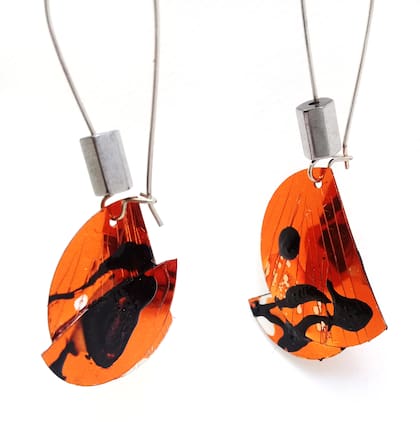 En su showroom de Villa Crespo hay amplia variedad de piezas de joyería contemporánea. Los aros tienen pintura informal sobre cobre metalizado y resina.