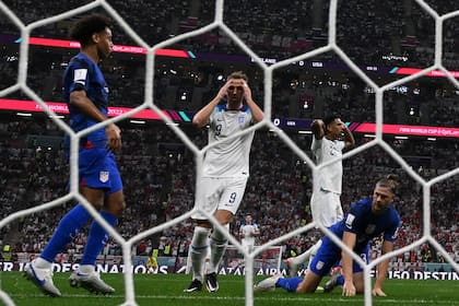 England's forward #09 Harry Kane (C) reacts after his shot at goal was blocked by USA's defender #03 Walker Zimmerman (R) during the Qatar 2022 World Cup Group B football match between England and USA at the Al-Bayt Stadium in Al Khor, north of Doha on November 25, 2022. (Photo by Patrick T. FALLON / AFP)