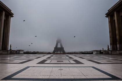 Esta imagen tomada el 11 de noviembre de 2020 muestra la explanada vacía del Trocadero y la Torre Eiffel parcialmente oculta por la niebla en París, ya que Francia se encuentra en un segundo bloqueo destinado a contener la propagación de la pandemia de coronavirus