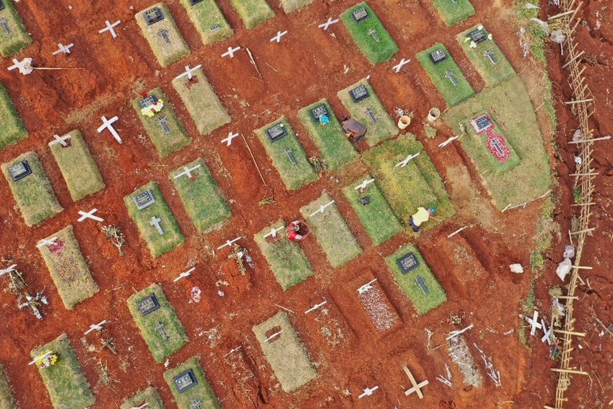 Esta imagen tomada en Yakarta el 16 de septiembre de 2020 muestra a los sepultureros trabajando durante un funeral por las víctimas del coronavirus