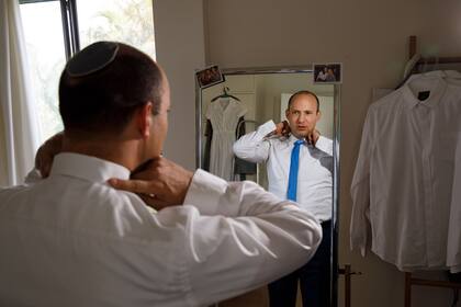 EXCLUSIVE: March 28, 2019 - Raanana, Israel: Naftali Bennett at home getting dressed. Naftali Bennett is an Israeli politician who led the Jewish Home party between 2012 and 2018. He has served as Israel's Minister of Education since 2015, and as the Minister of Diaspora Affairs since 2013. Between 2013 and 2015, he held the posts of Minister of Economy and Minister of Religious Services. In December 2018 Bennett was amongst the Jewish Home members of the Knesset to leave the party and form the breakaway New Right party. Bennett currently co-leads the New Right Party with Ayelet Shaked. (Ziv Koren/Polaris)