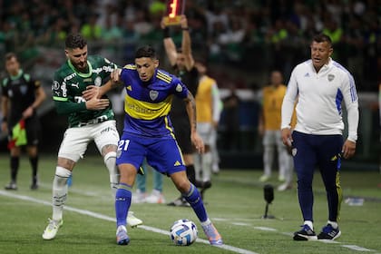 Ezequiel Fernandez aguanta la pelota frente a Ze Rafael ante la atenta mirada de Jorge Almirón