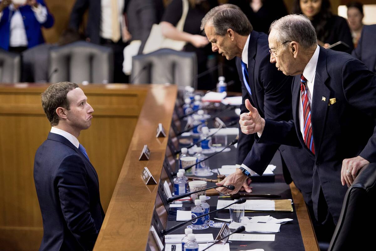 Facebook CEO Mark Zuckerberg (L) speaks with Senator John Thune (C), R-SD, and Senator Chuck Grassley (R), R-IA following a joint hearing of the Senate Commerce, Science and Transportation Committee and Senate Judiciary Committee on Capitol Hill April 10, 2018 in Washington, DC.
Facebook chief Mark Zuckerberg took personal responsibility Tuesday for the leak of data on tens of millions of its users, while warning of an "arms race" against Russian disinformation during a high stakes face-to-face with US lawmakers. / AFP PHOTO / Brendan Smialowski
