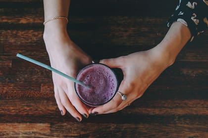Female hands with a glass of smoothies