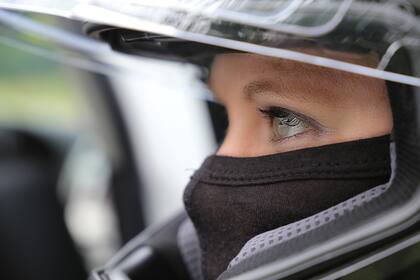 Female race car driver wearing helmet and balaclava