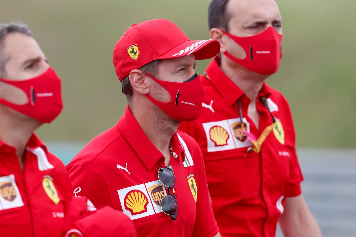 Ferrari driver Sebastian Vettel of Germany, center, inspects the track with his team at the Hungaroring racetrack in Mogyorod, Hungary, Thursday, July 16, 2020. The Hungarian Formula One Grand Prix race will take place on Sunday. (AP photo/Darko Bandic)