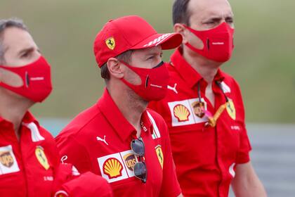 Ferrari driver Sebastian Vettel of Germany, center, inspects the track with his team at the Hungaroring racetrack in Mogyorod, Hungary, Thursday, July 16, 2020. The Hungarian Formula One Grand Prix race will take place on Sunday. (AP photo/Darko Bandic)