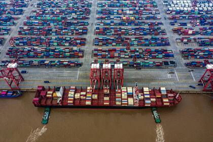 FILE -- A giant container ship docked at the Yangshan Port in Shanghai, China, May 27, 2019. As container ships have grown larger, many ports and canals have not made adjustments to accommodate them. Four months after the megaship Ever Given got stuck in the canal, neither the canal nor the shipping industry has addressed some of the most critical issues that led to the grounding. (Lam Yik Fei/The New York Times)