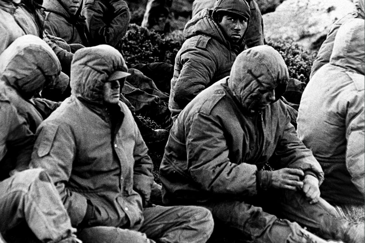 ** FILE ** Captured Argentinian soldiers are guarded by a British Royal Marine as they await transit out of the area at Goose Green, Falkland Islands, in this June 2, 1982 file photo. April 2 marks the 25th anniversary of the beginning of the war between Argentina and Great Britain over the possession of the islands, known as Malvinas by Argentines. The 10-week war killed 712 Argentines, 255 Britons and three islanders. (AP Photo/Martin Cleaver, File