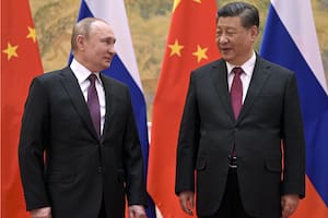 FILE - Chinese President Xi Jinping, right, and Russian President Vladimir Putin talk to each other during their meeting in Beijing, Feb. 4, 2022. China is the only friend that might help Russia blunt the impact of economic sanctions over its invasion of Ukraine, but President Xi Jinping government is giving no sign it might be willing to risk its own access to U.S. and European markets by doing too much. (Alexei Druzhinin, Sputnik, Kremlin Pool Photo via AP, Fil