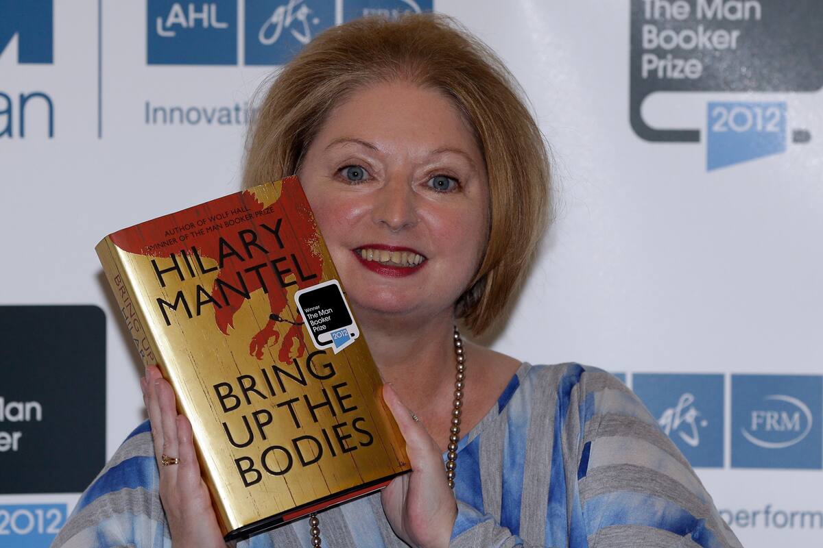 FILE - Hilary Mantel, winner of the Man Booker Prize for Fiction, poses with a copy of her book 'Bring up the Bodies', shortly after the award ceremony in central London, on Oct. 16, 2012. Mantel, the Booker Prize-winning author of the acclaimed √¢ˇÊ¨‡ÖìWolf Hall√¢ˇÊ¨ˇÊ¨ saga, has died, publisher HarperCollins said Friday Sept. 23, 2022. She was 70. (AP Photo/Lefteris Pitarakis, File)