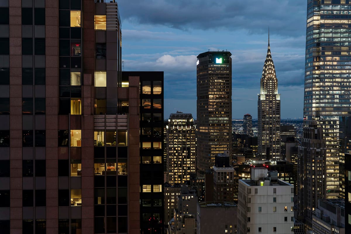 FILE Ñ The Chrysler Building, second right, whose fortunes have waned amid neglected repairs, a lack of modern amenities and vacancies, in New York at dusk, Sept. 28, 2022. Legal maneuvers and an empire in tatters leave the ownership of the once grand Manhattan skyscraper up in the air. (Karsten Moran/The New York Times)