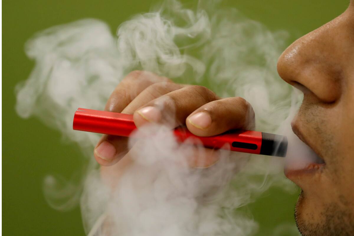 FILE PHOTO: A man uses a vape device in this illustration picture, September 19, 2019. REUTERS/Adnan Abidi/Illustration/File Photo